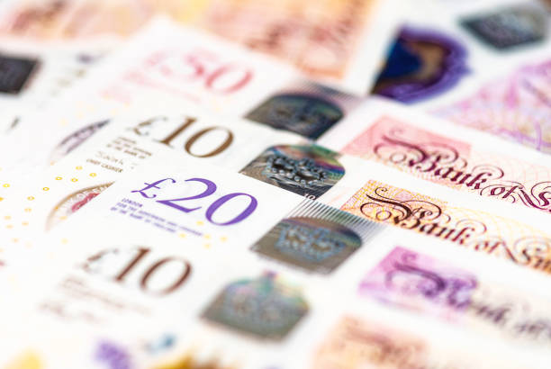 Collectoin of Bank of England notes in a row Macro image of several GBP notes issued by the Bank of England, including £10, £20 and £50 banknotes. british currency stock pictures, royalty-free photos & images