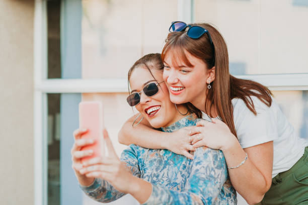 istock Lesbian couple hugging each other and taking a selfie 1410101094
