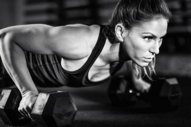 istock Cross training. Young woman exercising at the gym 1410102211