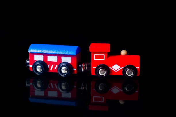 istock Children toy colored wooden train isolated on black background 1410102498