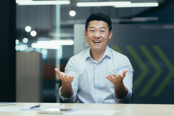 istock Successful and happy Asian businessman looking at camera, talking on video call 1410104134