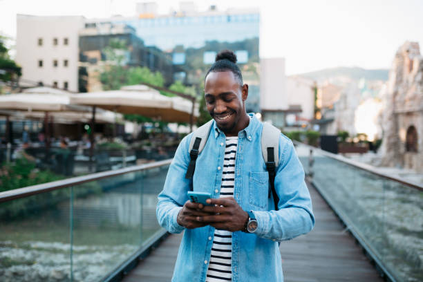 istock Happy young man using a smart phone outdoors 1410104183