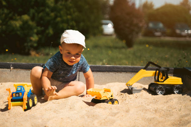 istock Child playing in sandbox. Little boy having fun on playground in sandpit. Outdoor creative activities for kids. Summer and childhood concept 1410104465