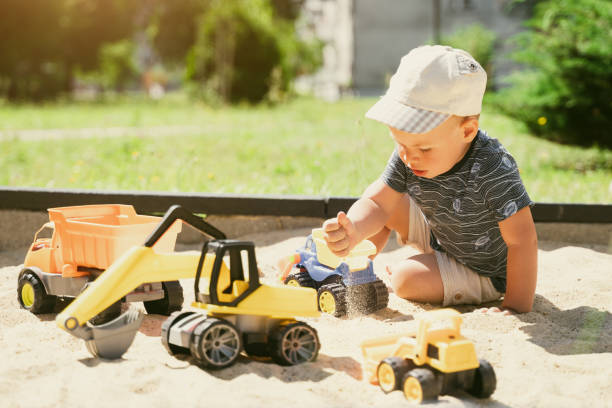 istock Child playing in sandbox. Little boy having fun on playground in sandpit. Outdoor creative activities for kids. Summer and childhood concept 1410104467