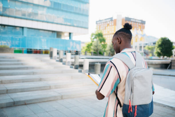 istock Young adult university student going to class 1410104673