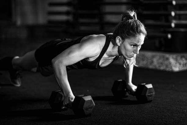 istock Cross training. Young woman exercising at the gym 1410105707