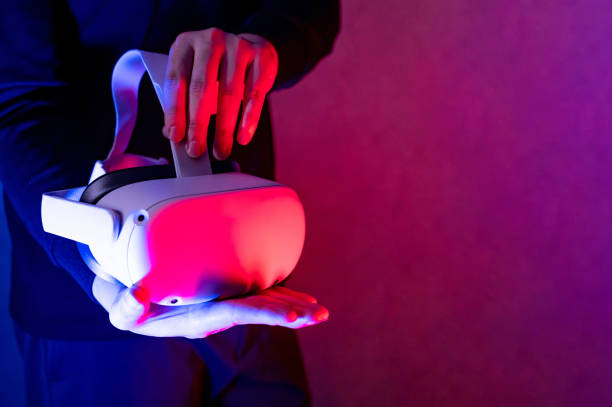 istock Male gamer hands holding VR goggles 1410106032