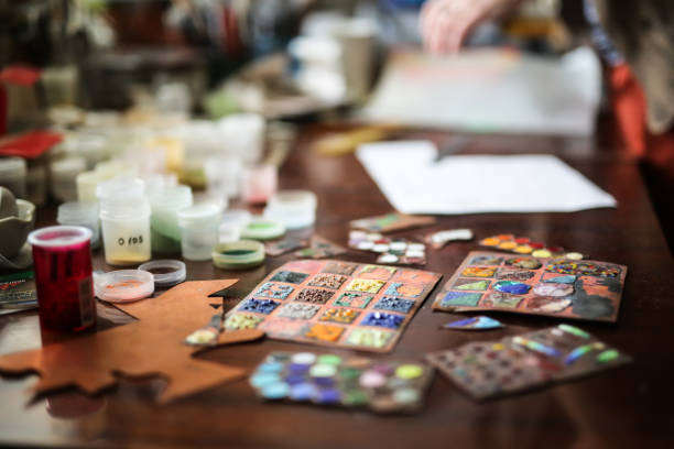 istock artist's studio samples of enamels on table, top view 1410106211