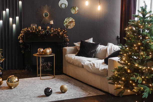 istock Tver, Russia-November 10, 2021. Christmas interior with a beautiful Christmas tree, sofa, light bulbs and dark background. 1410106314