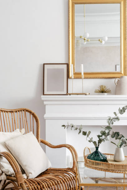 istock Wicker chair with white pillows close to side table 1410106318