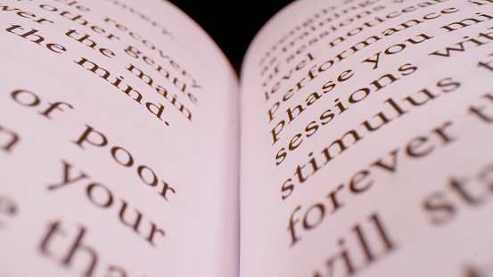 Book resting on a fine-grained wooden desk. The text is out of focus, but it's a pre-1942 edition of The Works of Oscar Wilde (the writer, playwright and wit who lived from 1854 to 1900).