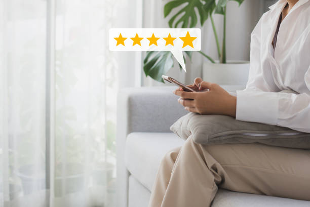 istock Woman customer hand pressing on smartphone screen with choose five star rating feedback icon and press level excellent rank for giving best score point to review the customer service. 1410107504