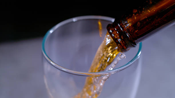 istock CLOSE UP, BOKEH: Gently blurred motion of pouring cold beer from bottle in glass 1410107507