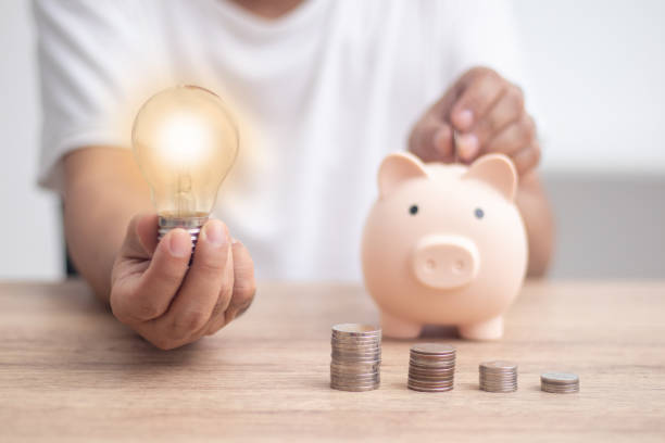 istock man holding a light bulb with piggy bank money saving concept 1410108826