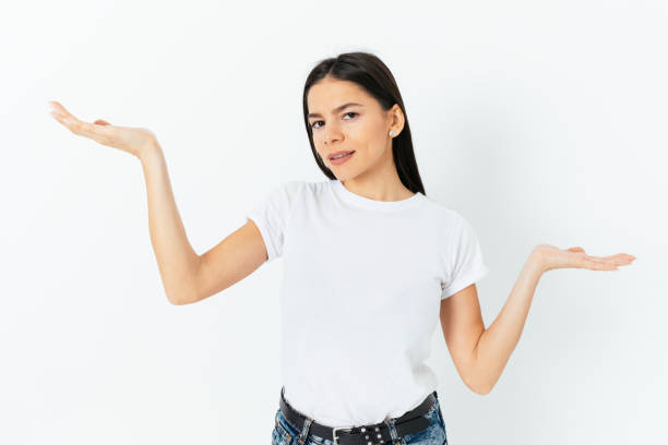 istock Portrait young woman comparing something, showing empty palms 1410109387