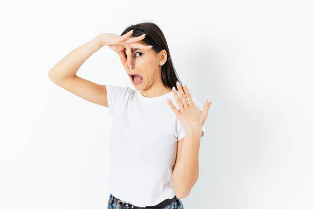 istock Bad smell, young woman clamped her nose with disgusted expression 1410109451