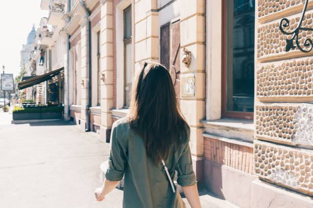 istock Rear view young woman with long hair walking 1410109509