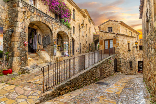 the medieval stone streets of pals spain at sunset after a summer rainstorm along the costa brava coast. - spain gerona architecture building exterior imagens e fotografias de stock