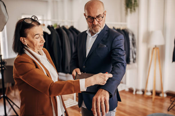 istock Saleswoman and customer picking textile for suit 1410114137