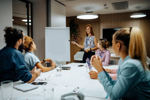 istock Employee in office standing near the blank flip chart, suitable for copy 1410114684