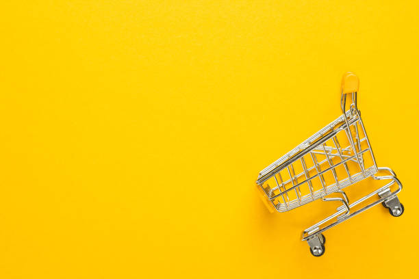 shopping trolley on yellow background