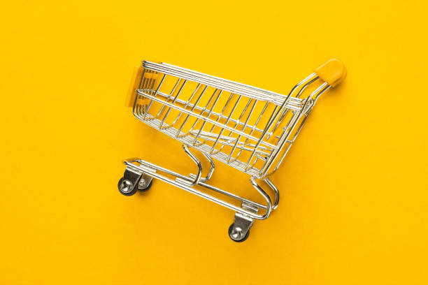 istock shopping trolley on yellow background 1410115634