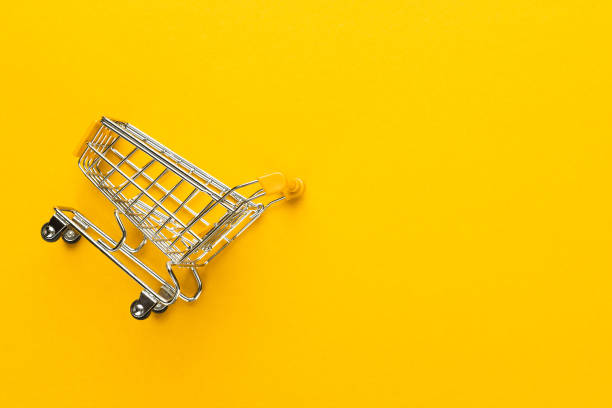 istock shopping trolley on yellow background 1410115635