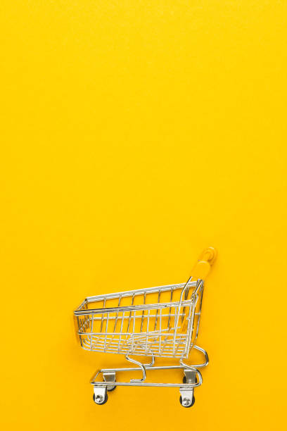 istock shopping trolley on yellow background 1410115636