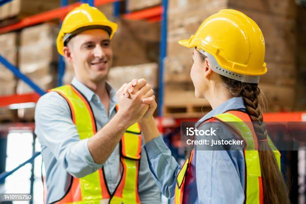 Warehouse Workers Soul Brother Handshake Thumb Clasp Handshake Or Homie Handshake With Blurred Factory Warehouse Background Success And Teamwork Concepts Stock Photo - Download Image Now