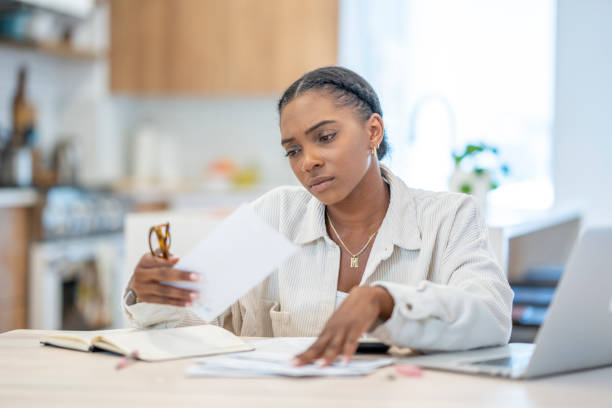 istock Woman Paying Bills At Home 1410116153