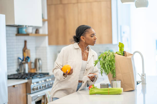 istock Woman Puzzled Reviewing Her Grocery Bill 1410116156