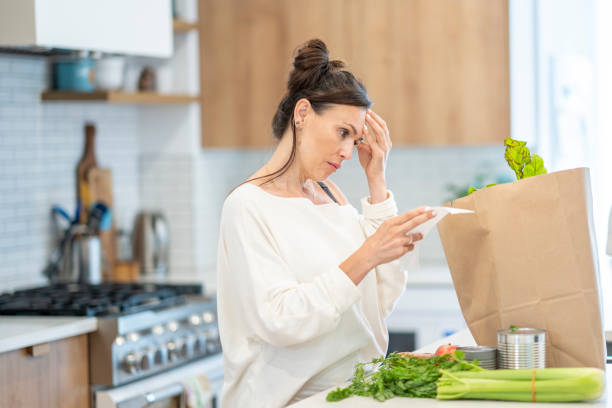 istock Woman Reviewing Grocery Bill 1410116167
