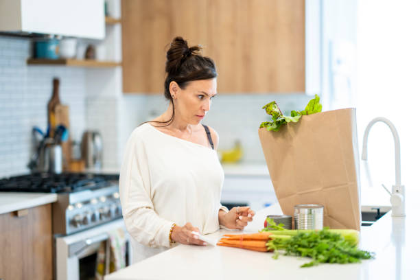 istock Woman Reviewing Grocery Bill 1410116174