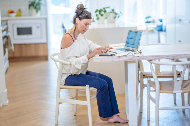 istock Woman Paying Bills At Home 1410116191