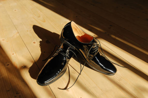 istock Black men's shoes in bright sunshine 1410117248