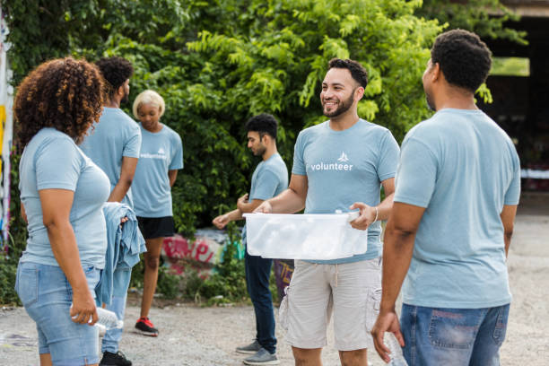istock Volunteers stand together and talk 1410117389