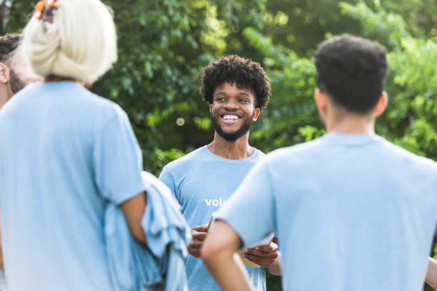 istock Volunteers stand in a circle to share encouraging stories 1410117433