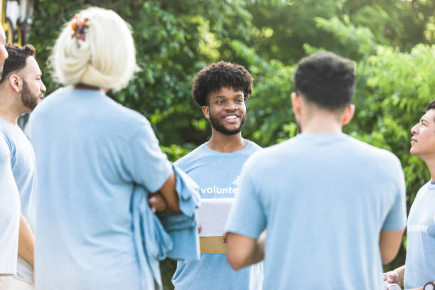 istock Coworkers stand in a group and talk 1410117435