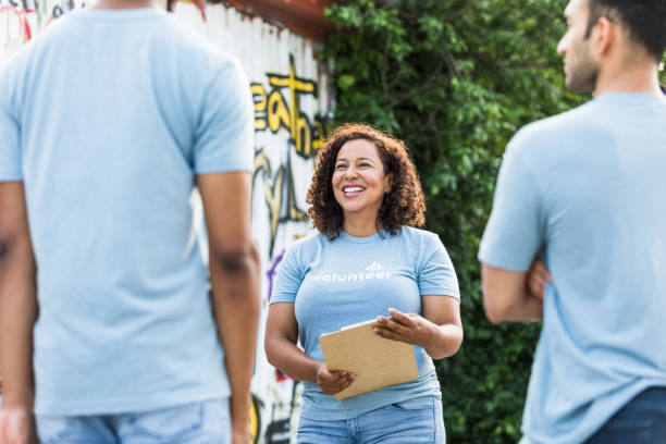istock Community center manager talks to the volunteers 1410117452