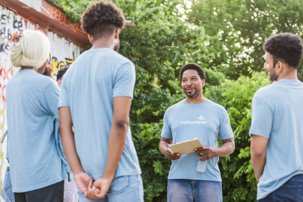 istock Friends stand together and talk about how to best help 1410117473