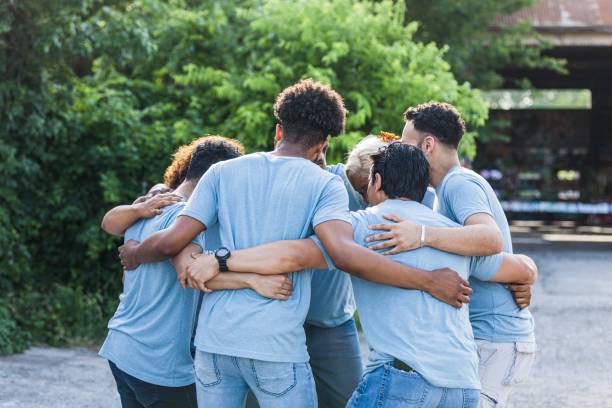 istock Friends participate in a group hug 1410117484