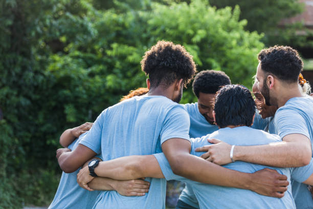 istock Diverse group of people embrace each other 1410117498