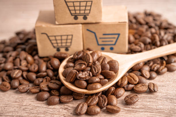 Box with shopping cart logo symbol on coffee beans, Import Export Shopping online or eCommerce delivery service store product shipping, trade, supplier concept. stock photo
