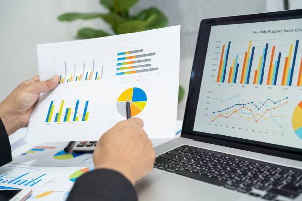 istock Asian accountant working and analyzing financial reports project accounting with chart graph and calculator in modern office, finance and business concept. 1410119118
