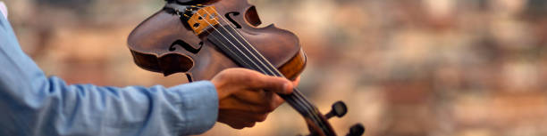 istock Linkedin banner with an inspired musician holding a violin in his hand 1410122644