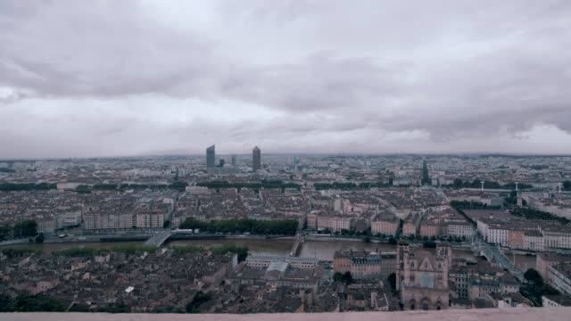 A forward steadicam movement in wide angle shot of Lyon city in France, above the city with a forecast day.