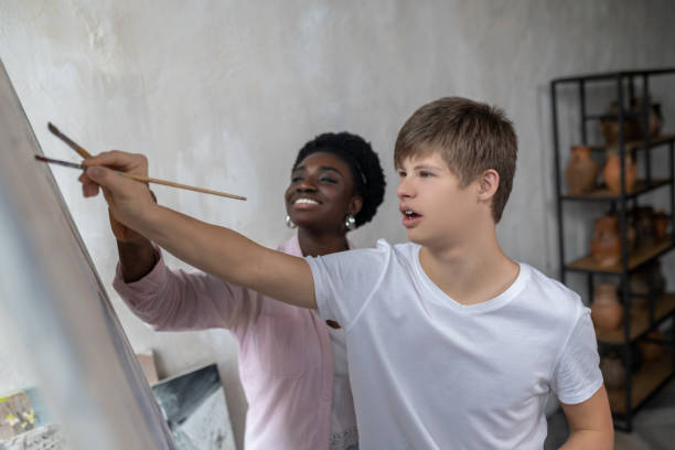 istock A tutor and a student near the easel looking positive 1410123022