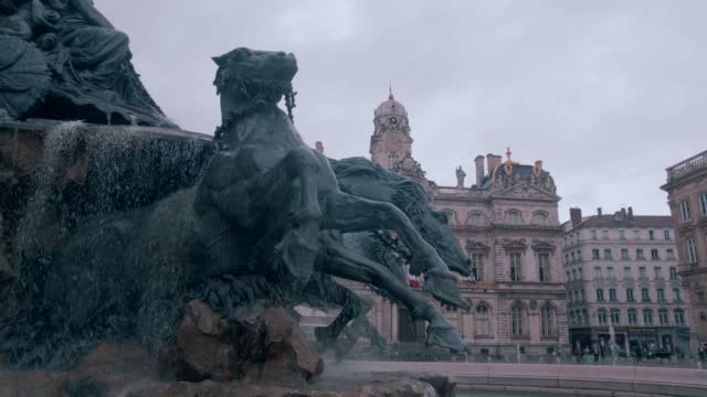 Footage of Fontaine Bartholdi at Place des Terreaux in the City of Lyon a famous sculpture in the city. In background the Hotel de ville of the city
