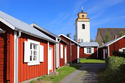 Old red painted cabins in front of the church in the Gammelstad church town.