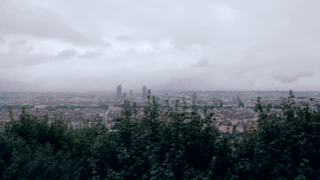 A cinematic forward steadicam movement in wide angle shot of Lyon city in France, above the city with a forecast day.